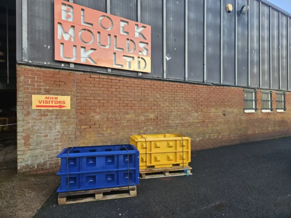 Blue and yellow block moulds on pallets