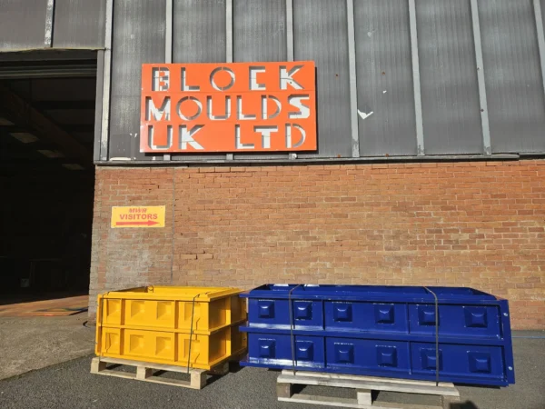 Yellow and blue concrete block moulds on pallets