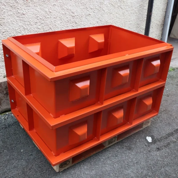 Orange interlocking concrete block mould on a pallet